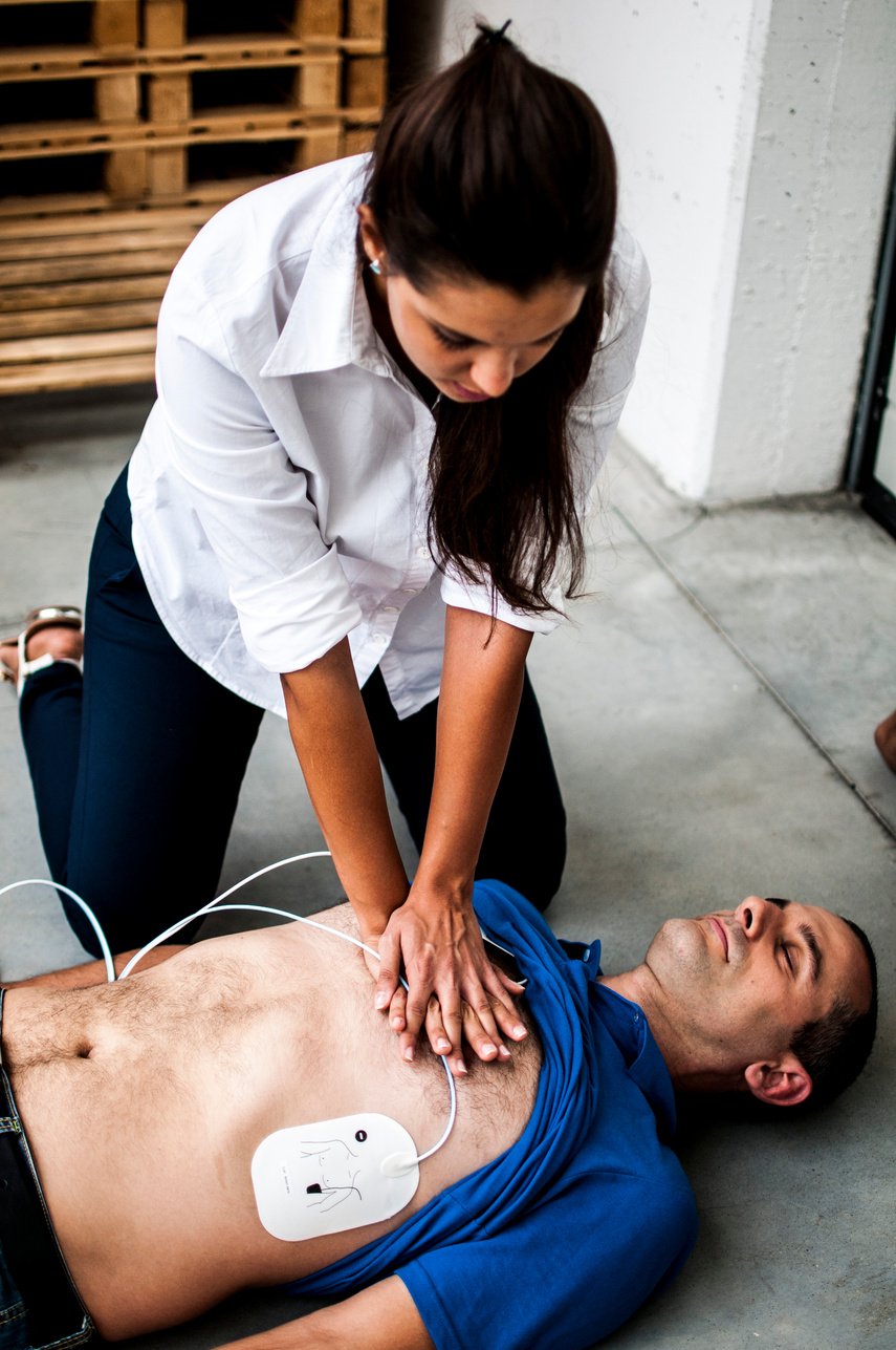 girl assisting an unconscious man after fatal accident